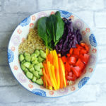 A vegan & gluten-free grain bowl topped with rainbow veggies