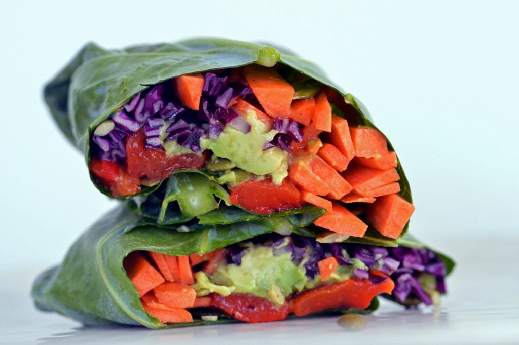 vegan collard green wrap filled with colorful vegetables