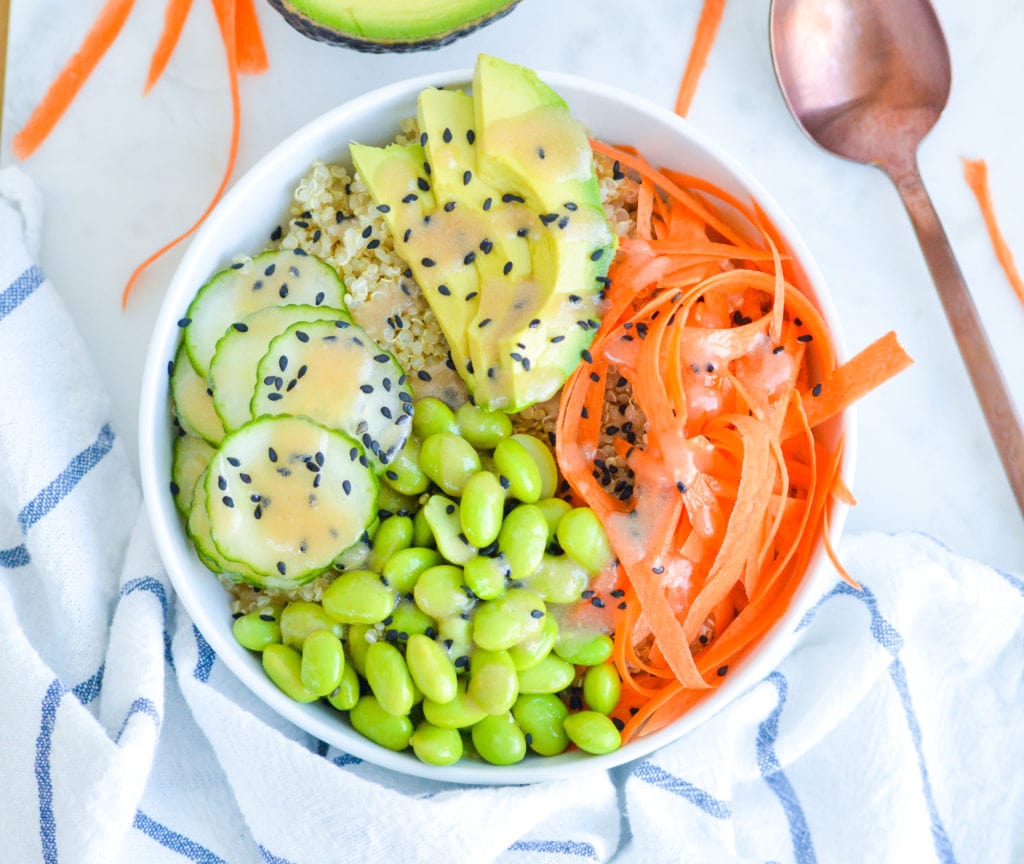 quinoa sushi bowl with edamame, carrots, avocado, cucumber and a miso dressing