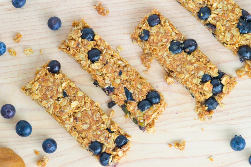 These No-Bake Blueberry Granola bars feature fresh blueberries and have very little added sugar. With just a few simple ingredients and no oven required, there are the perfect nutritious snack to whip up in the heat of the summer or anytime throughout the year! #nobake #granolabars #blueberrybars #healthysnack #healthygranolabar