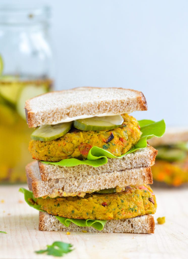 stacked chickpea veggie burger on bread with pickles