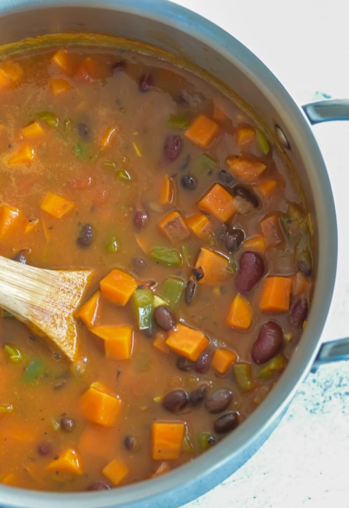 veggies and broth in a pot for pumpkin chili