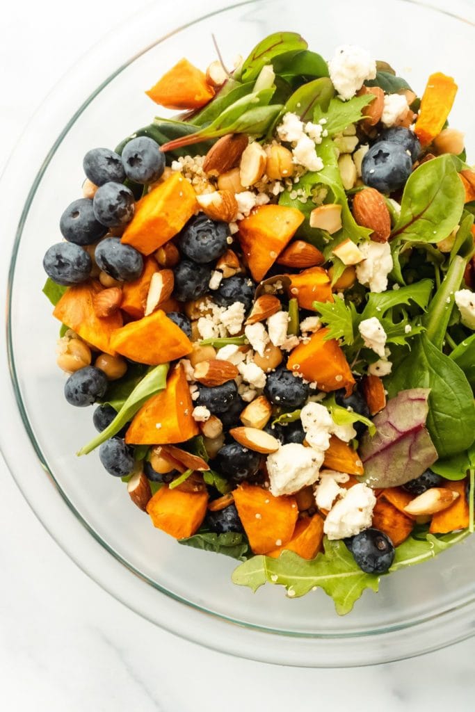 leafy green salad with blueberries, sweet potatoes and nuts