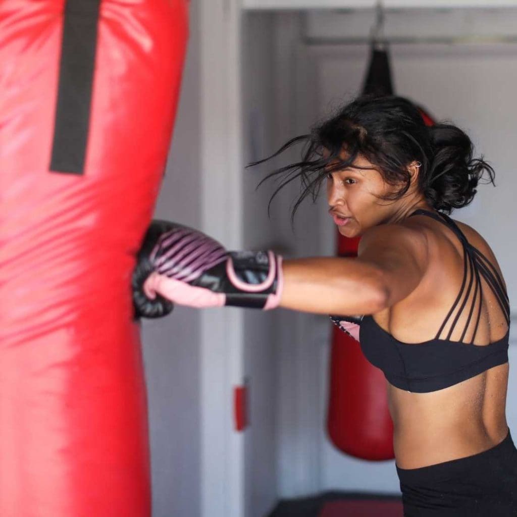 woman boxer hitting a punching bag