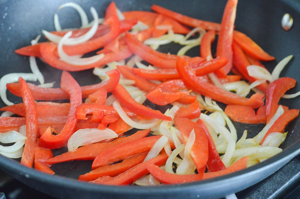 onions and peppers in a pan