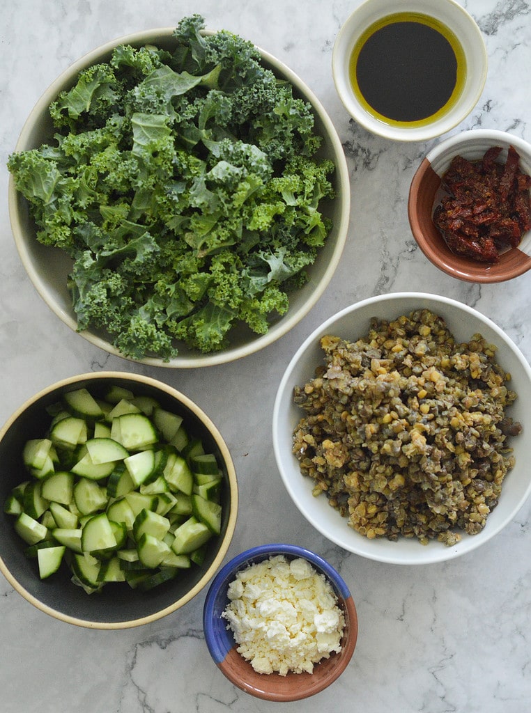 ingredients for a lentil salad in separate bowls
