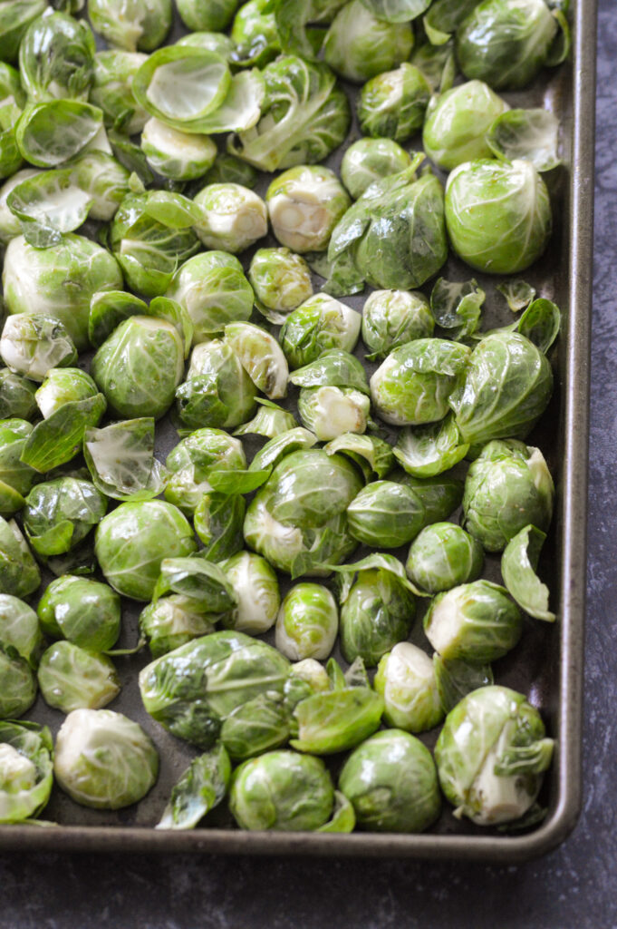 brussels sprouts face down on a baking sheet