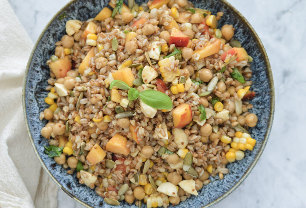 healthy farro salad with corn, peaches, and more